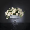 Artificial flower arrangement in glass